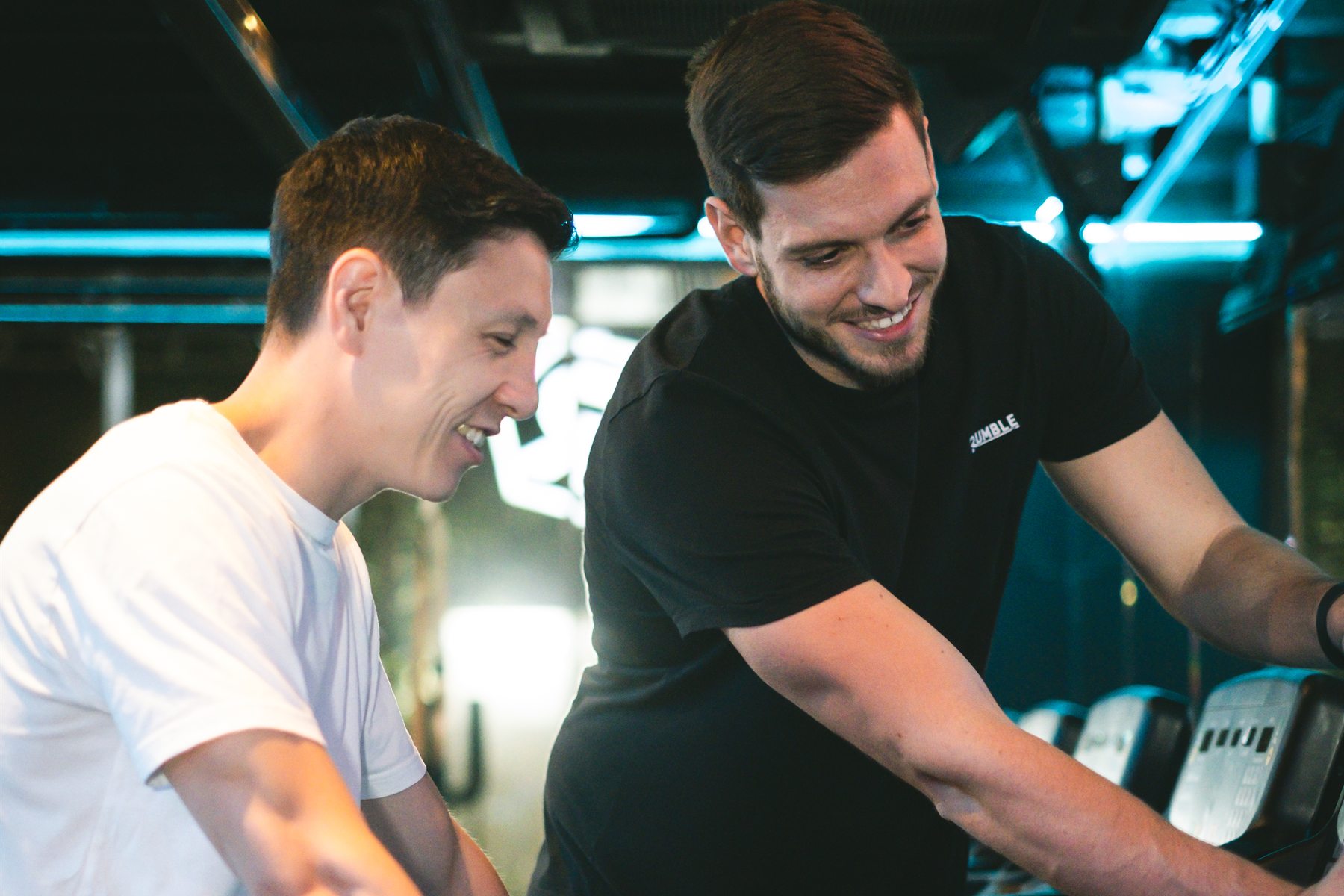 A Rumble coach setting up a member’s treadmill before a class at Rumble Dalston