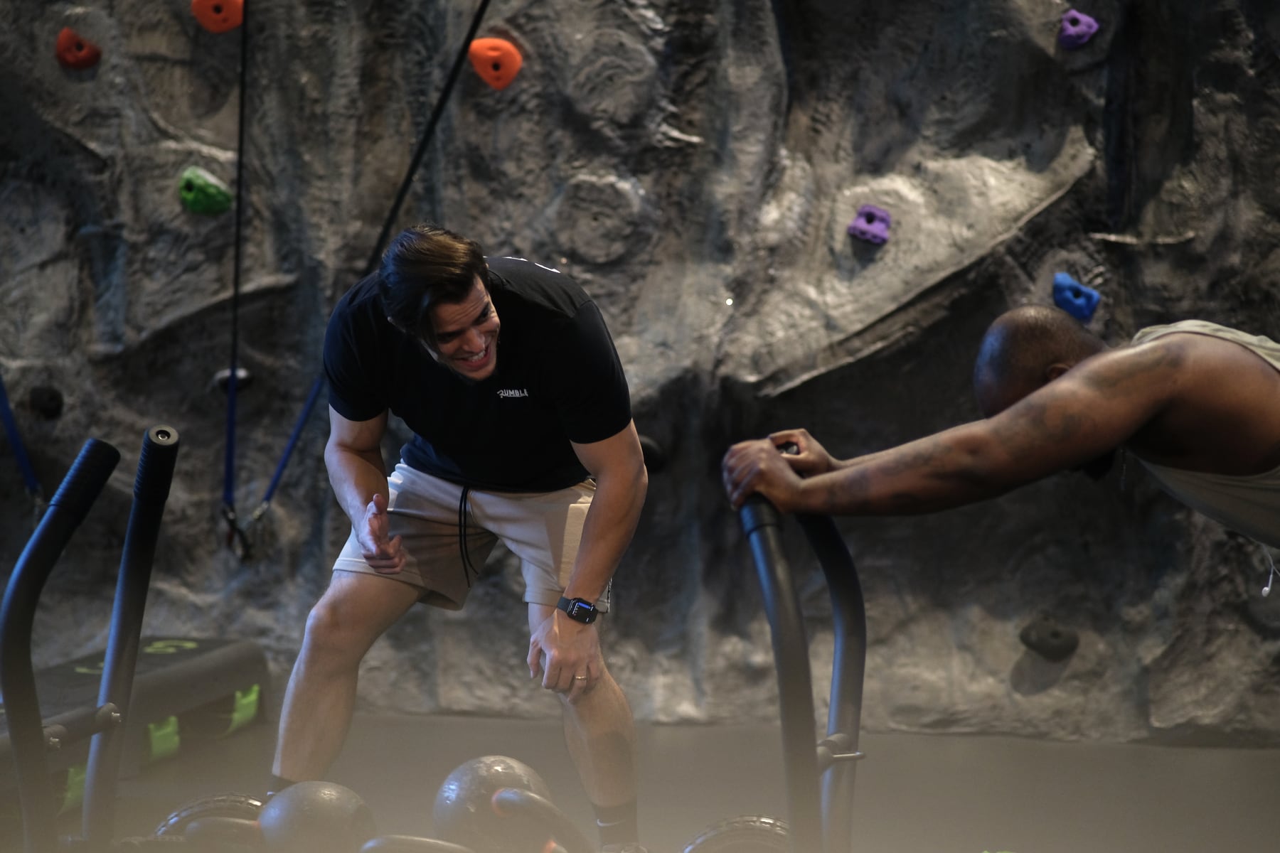 A Rumble coach working one-to-one with a member on a quiet studio floor