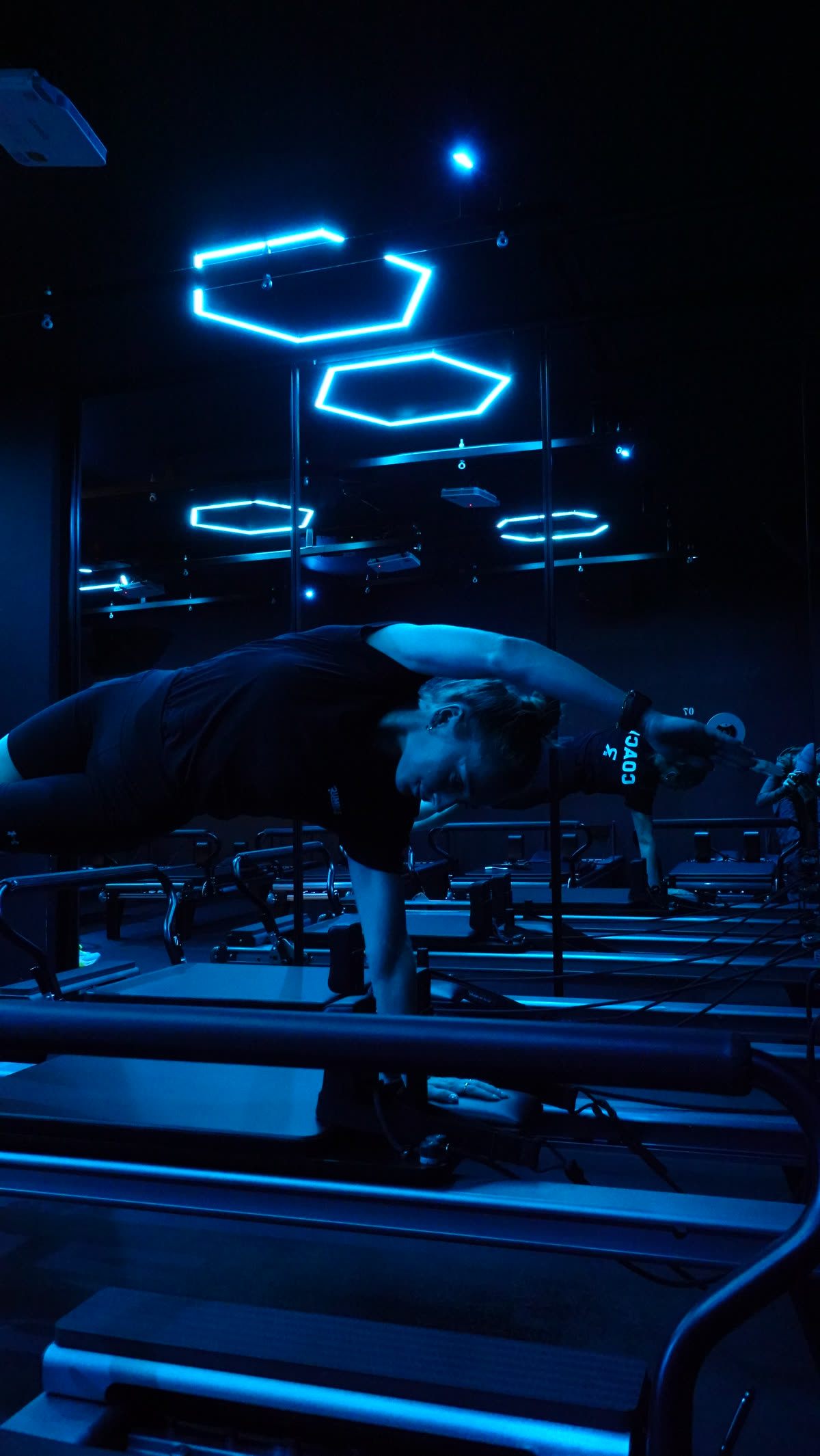 Coached stretch work beside the reformers in the Re.Former studio