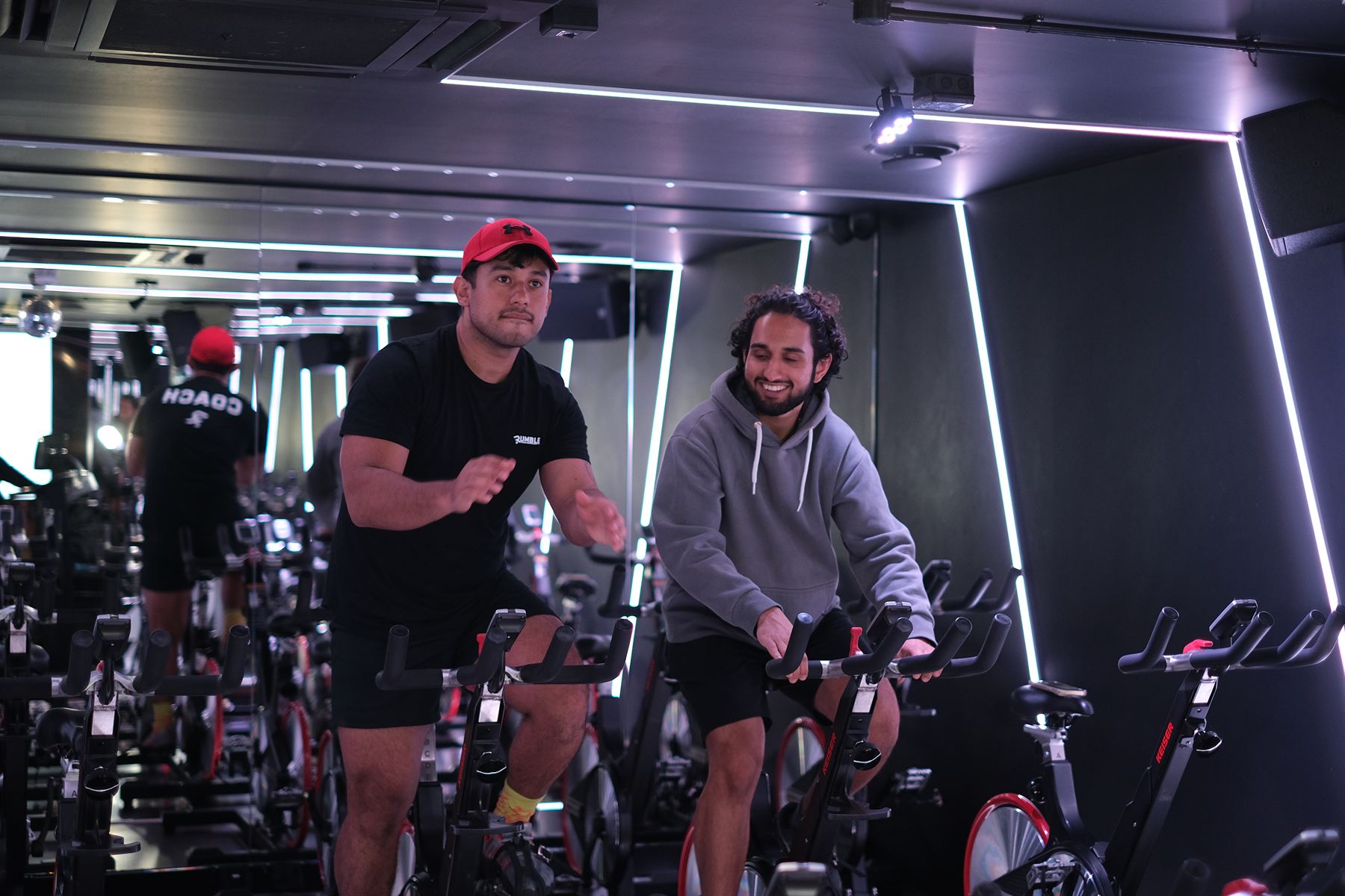 A coach setting up a first-timer on the bikes at Rumble Dalston